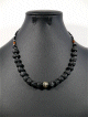Collier ethnique artisanal 20 pierres noires de 1cm agremente de fines perles argentees