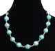 Collier ethnique artisanal imitation boules turquoises agrementees d'armatures argentees avec des perles bleues et en bois