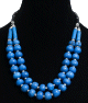 Collier ethnique artisanal deux rangs imitation pierres rondes bleues agencees de perles argentees, de tubes bleus et noirs