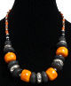 Collier ethnique artisanal imitation disques oranges, noires et argentees agrementees de perles