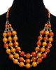 Collier ethnique artisanal imitation grosses perles oranges agencees de pieces argentees ciselees