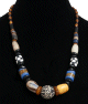 Collier ethnique artisanal imitation pierres cylindrees multicolores agencees de perles noires et en bois