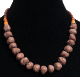 Collier ethnique artisanal imitation boules marrons difformes separees de perles noires, compose d'autres perles marrons