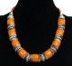 Collier ethnique artisanal imitation corail orange assorti de perles en bois et d'agrements en metal