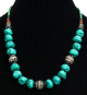Collier ethnique artisanal imitation pierres bleues vertes agrementees de perles noires, vertes, argentees et d'autres en bois