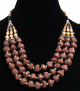 Collier ethnique artisanal trois rangs imitation pierres marrons et perles agencees de pieces argentees ciselees