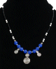 Collier ethnique artisanal boules bleues agence de perles noires et blanches avec agrements argentes et breloques spirales
