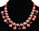 Collier ethnique artisanal imitation pierres noires et rouges agencees de perles et agremente de pieces en metal argente