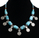 Collier ethnique artisanal cylindres imitation corail turquoise avec armatures en metal argente cisele agremente de pendentifs tourbillon spirale argentes