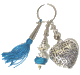 Porte-cles artisanal grand coeur et breloques en metal argente cisele et pompon en sabra bleu-ciel