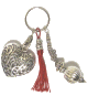 Porte-cles artisanal grand coeur et breloques en metal argente cisele et pompon en sabra rouge