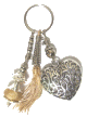 Porte-cles artisanal grand coeur et breloques en metal argente cisele et pompon en sabra beige